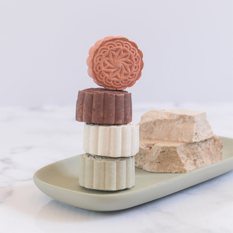 Modani Naturals Clay Face Mask displayed stacked on ceramic dish.