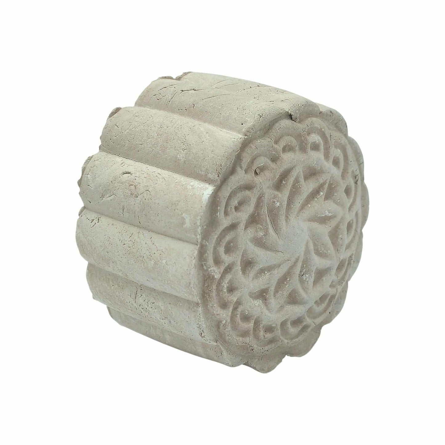 Decorative solid clay face mask bar with intricate carvings on a white background