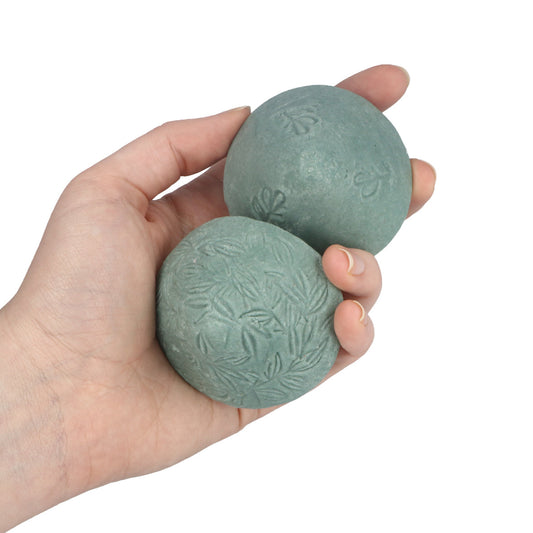 Hands holding the Modani Naturals Ocean Ritual Beauty Stone shampoo bar, a pH-balanced syndet cleansing bar for hair, face and body