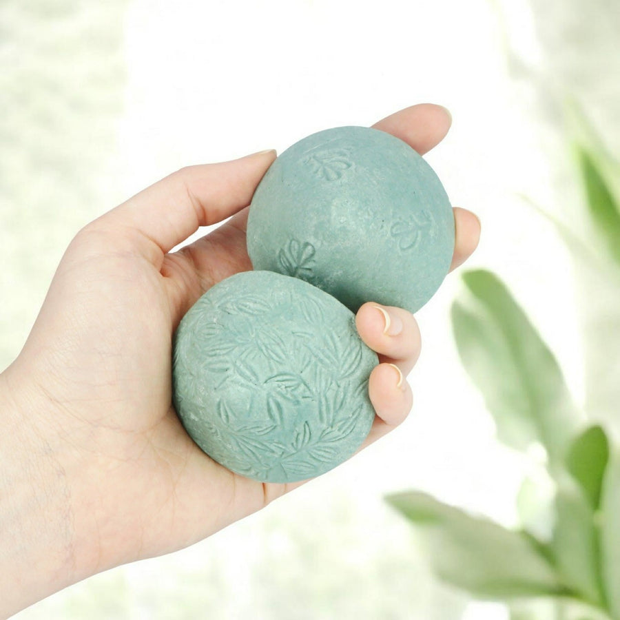 Modani Solid Shampoo bar collection resting on stone platform. 