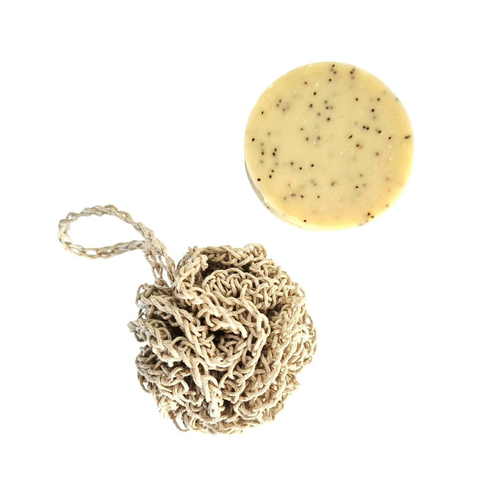 Hemp face cleansing pouf and round poppyseed soap on a white background