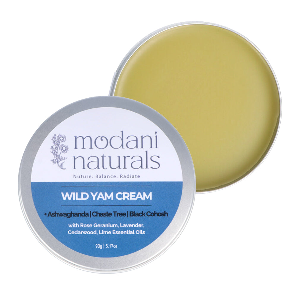 A round silver tin of Modani Naturals Wild Yam Cream, with the lid off to reveal a pale yellow-green cream inside, set against a plain white background.