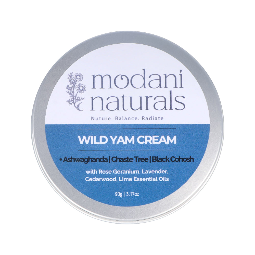 A round silver metal tin of Modani Naturals Wild Yam Cream, featuring a white and blue label with botanical illustrations, set against a plain white background.