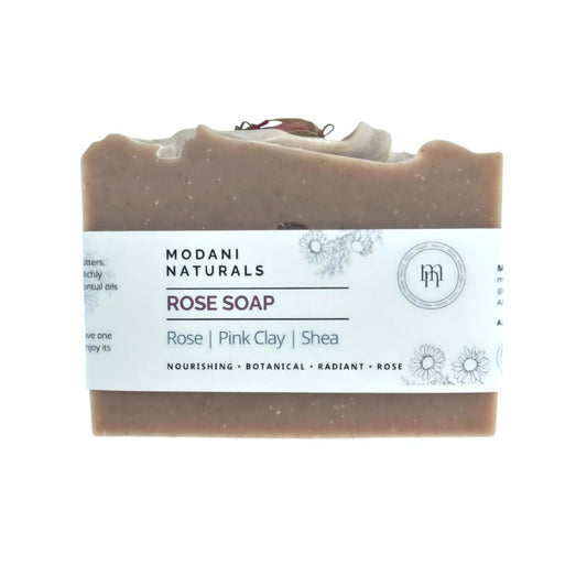 A rectangular bar of Modani Naturals Rose Soap in Pink Clay and Shea, featuring a white paper label with botanical illustrations, set against a plain white background.