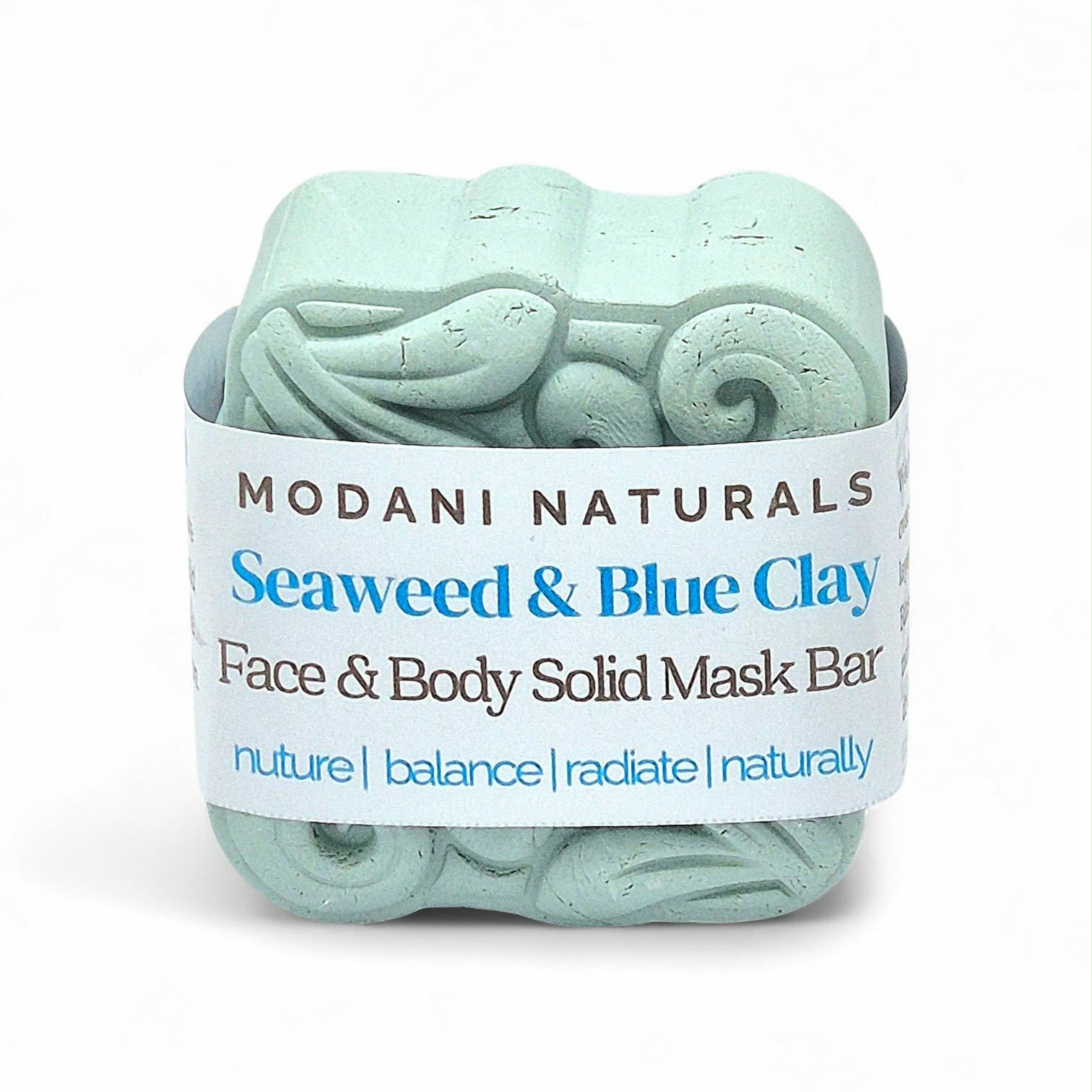 Seaweed and blue clay face and body solid mask bar with Modani Naturals packaging on a white background