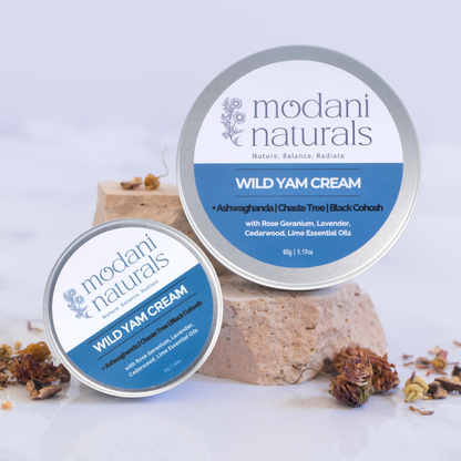 Modani Naturals Wild Yam Creams in 2 sizes, 90g & 40g tins sitting on stone blocks showing labels on white background.  