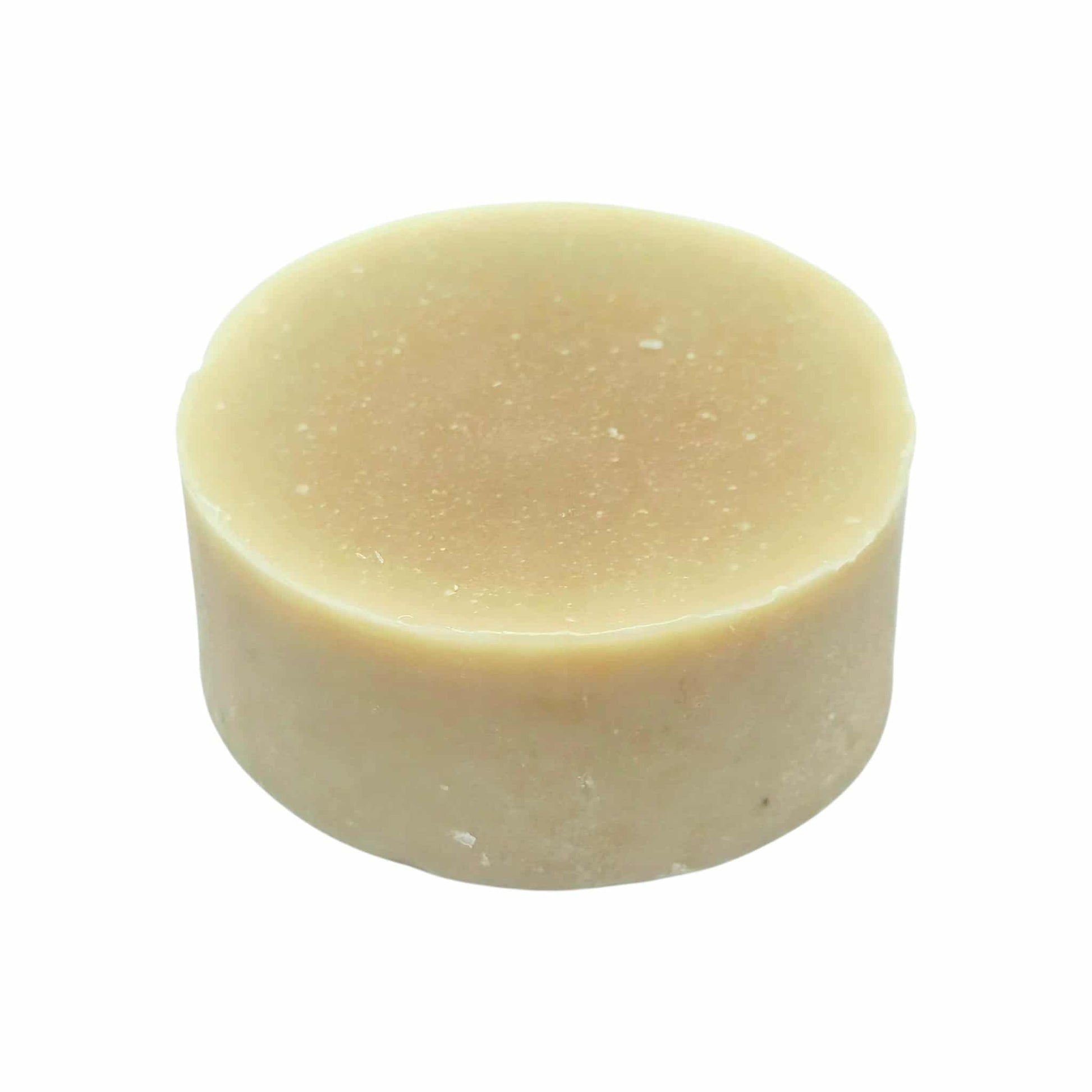 Honey colour bar of botanical soap on a white background
