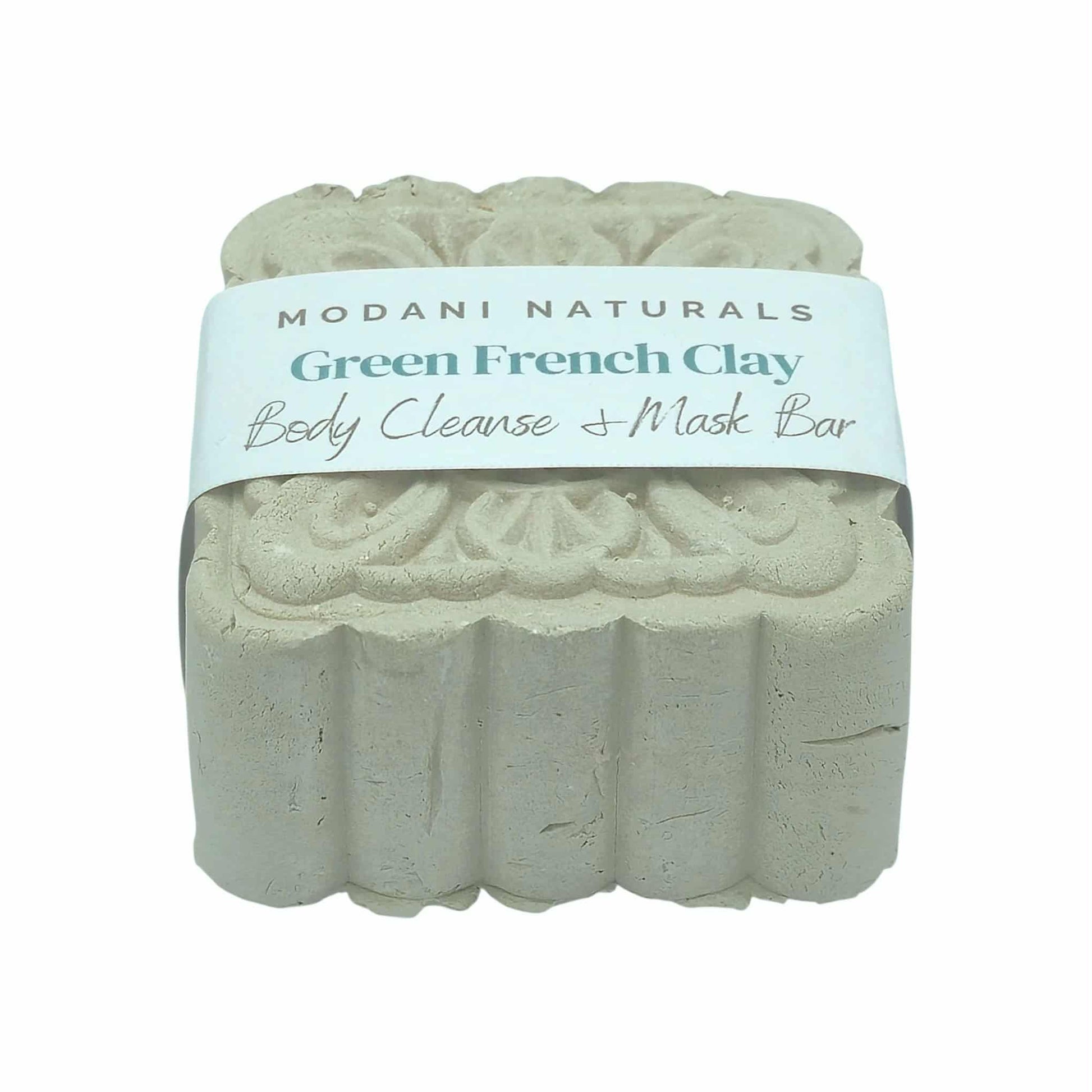 Green French Clay body cleanse mask bar with intricate floral pattern by Modani Naturals with label on a white background. 