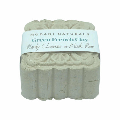 Green French Clay body cleanse mask bar with intricate floral pattern by Modani Naturals with label on a white background. 