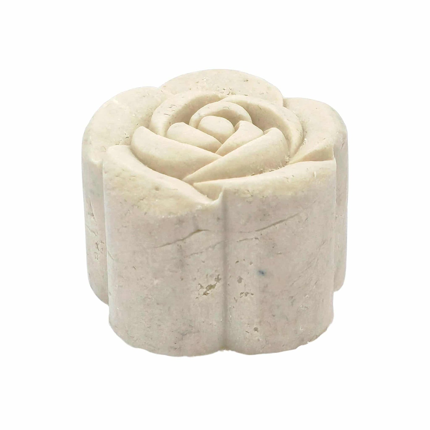 Solid white shampoo bar with rose shape on a white background showing side view. 